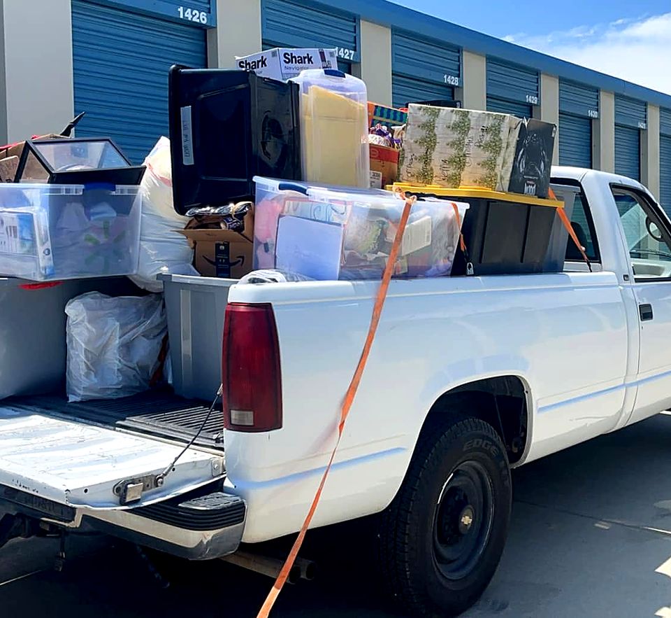 Loaded pickup strapped down at a storage facility