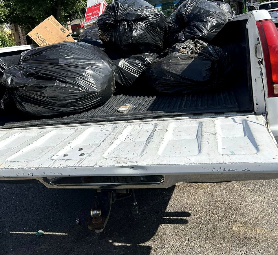 Truck bed full of bagged junk from a cleanout job